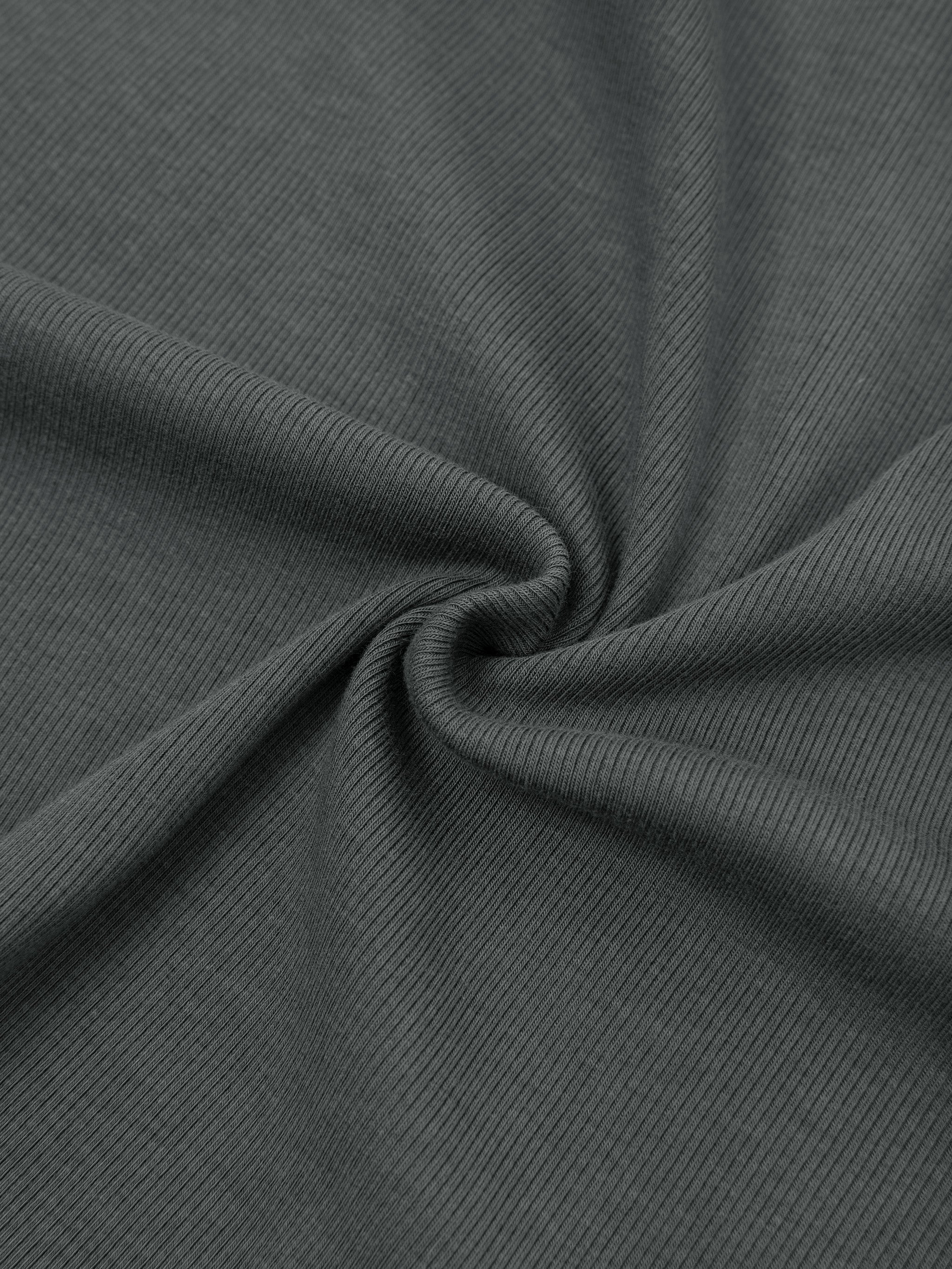 Close-up of soft dark grey ribbed fabric texture with folds, apparel material detail