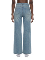 Back view of women's vintage wash flared leg jeans in light blue denim