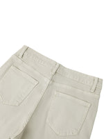 Back view of women's vintage wash flared leg jeans in light beige with two rear pockets