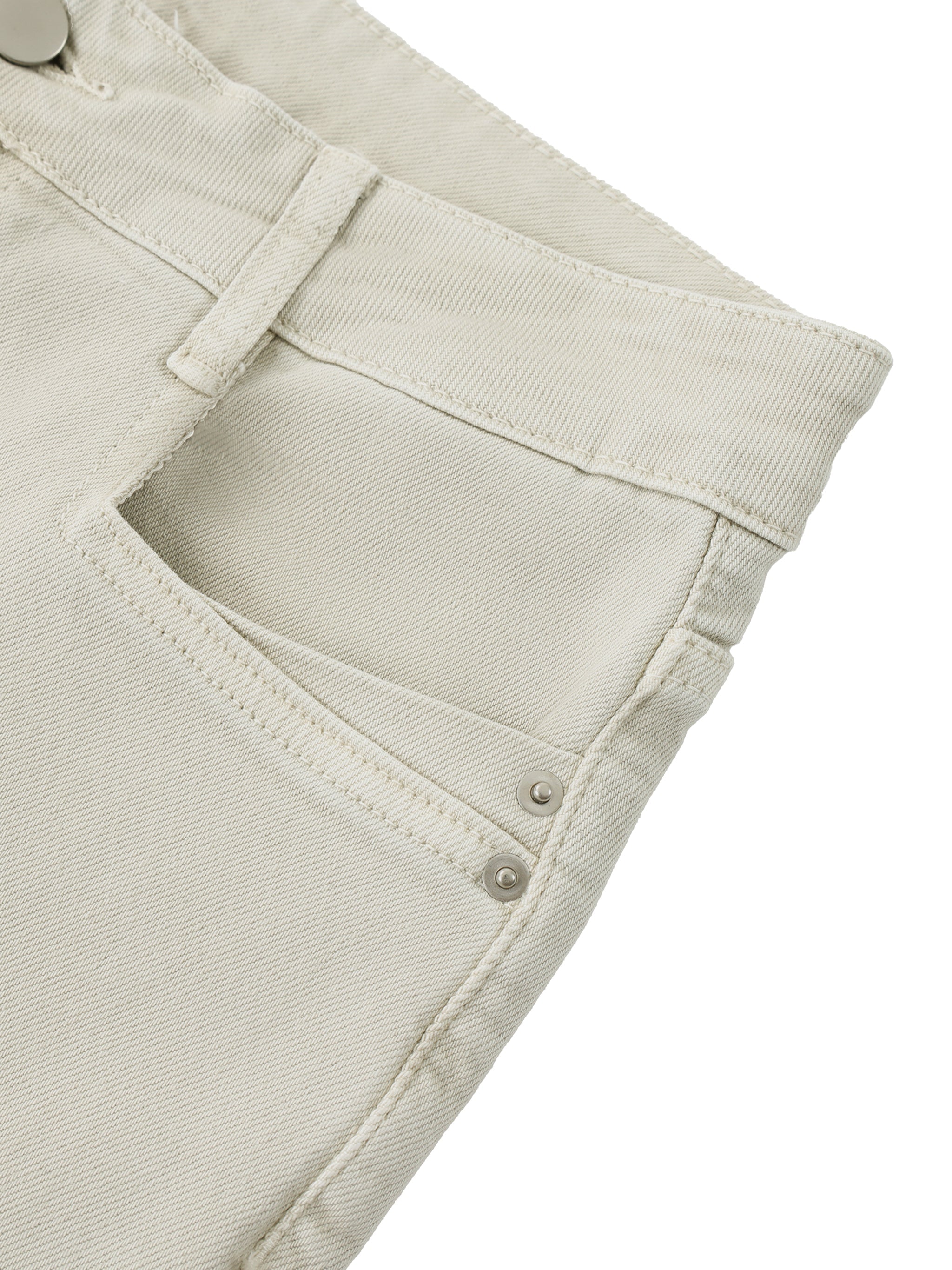 Close-up of light beige women's vintage wash flared leg jeans pocket and waistband