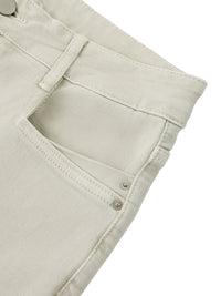 Close-up of light beige women's vintage wash flared leg jeans pocket and waistband