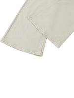 Close-up of light beige vintage wash flared leg jeans with visible stitching details.
