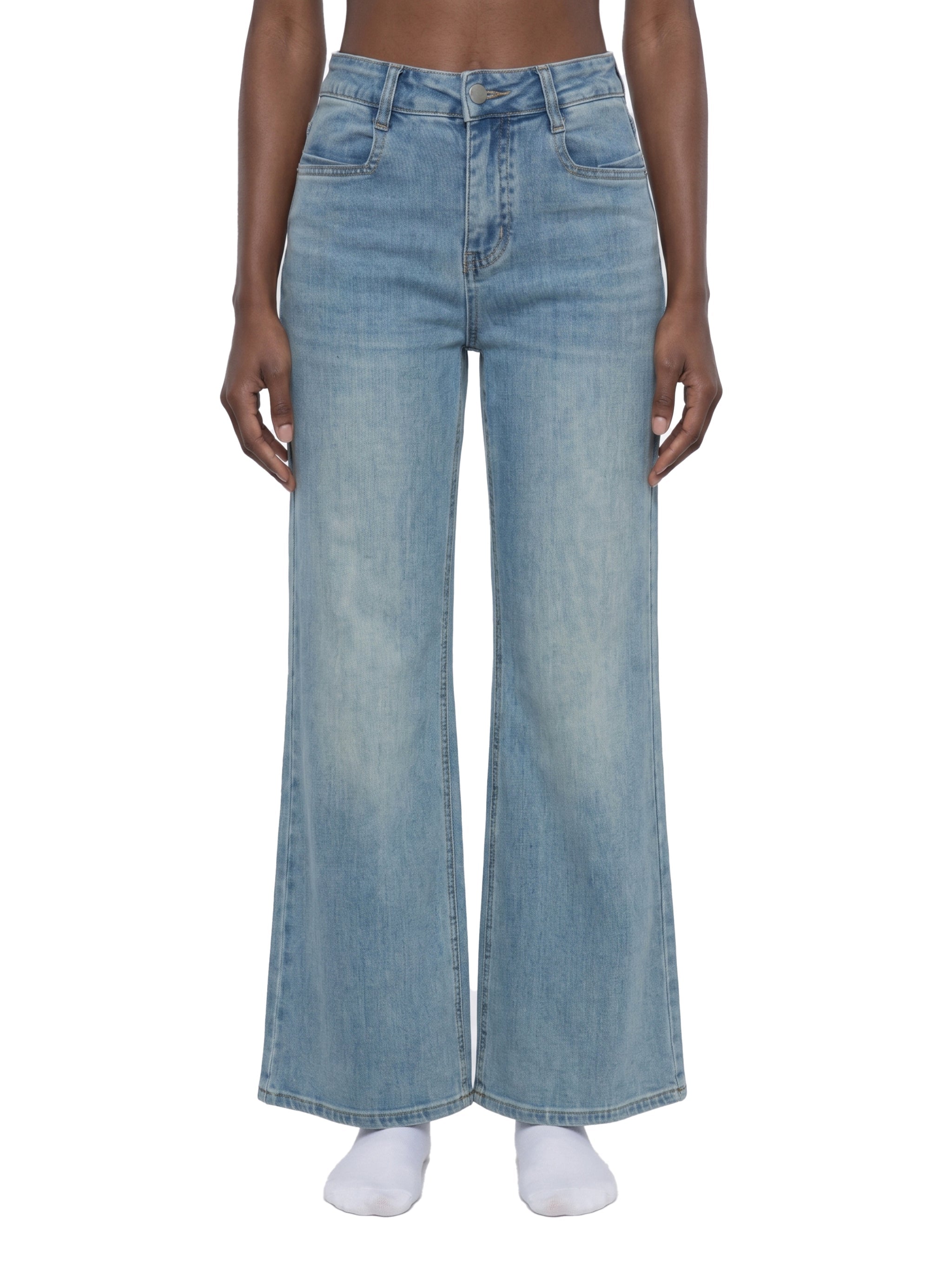 Women's vintage wash high-waisted flared leg jeans on model, front view