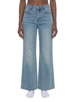 Women's vintage wash high-waisted flared leg jeans on model, front view