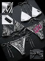 Zebra print string bikini set with contrasting black and white patterns and tie closures.