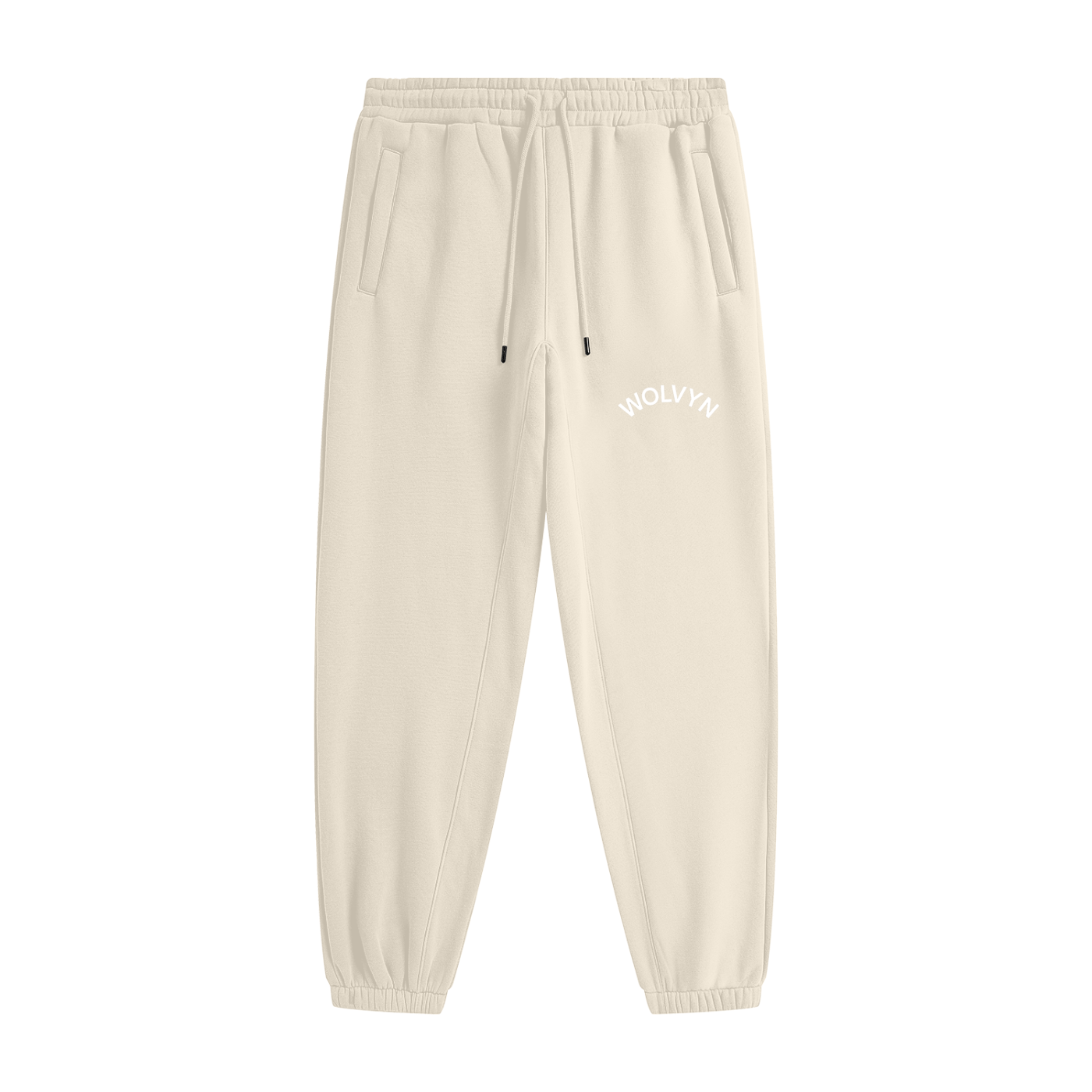 Beige heavyweight fleece joggers with elastic waistband, drawstrings, side pockets, and 'WOLVYN' text on the hip.