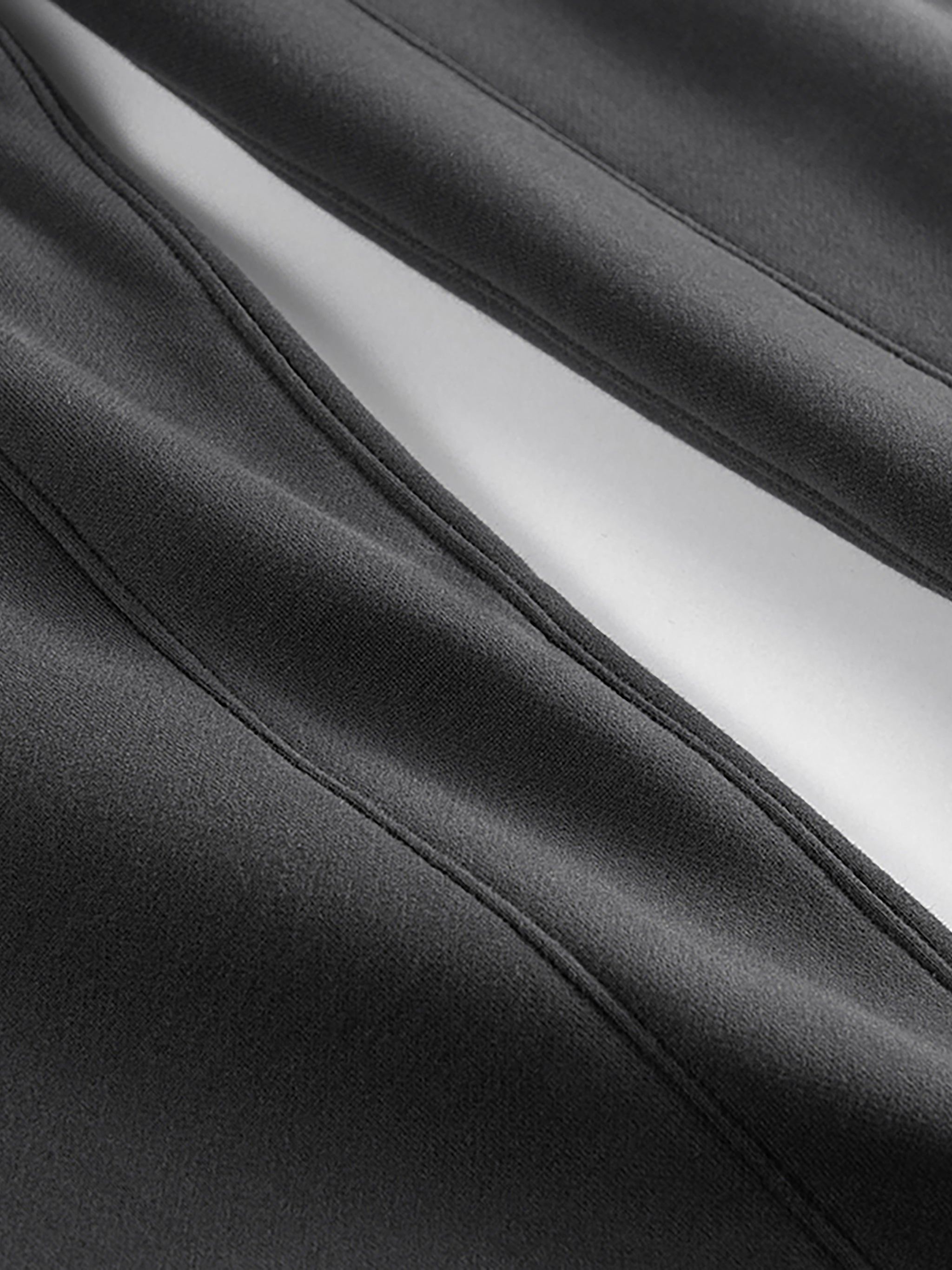 Close-up of heavyweight fleece joggers fabric in dark gray showing soft texture and stitching