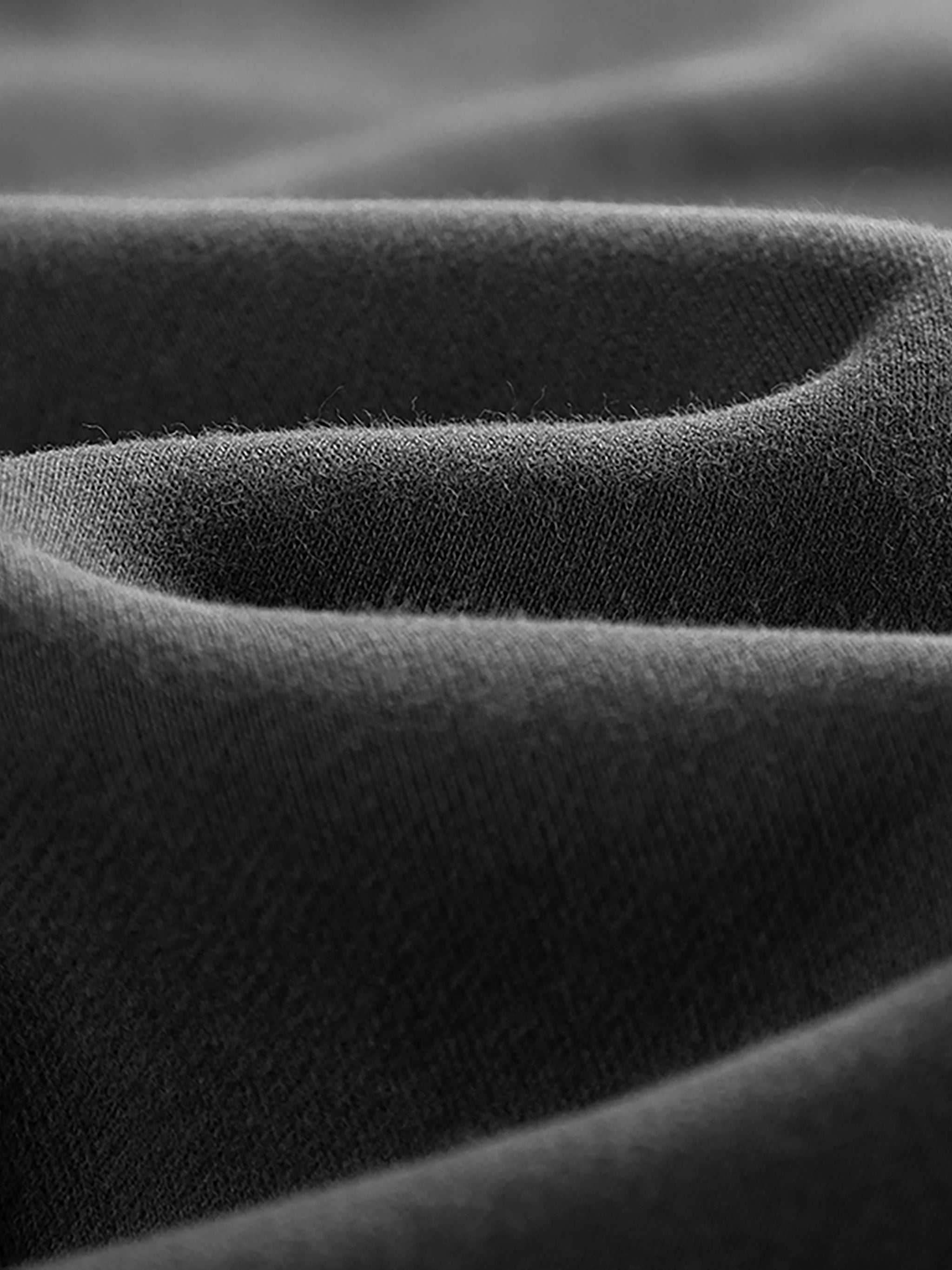Close-up of heavyweight black fleece jogger fabric texture