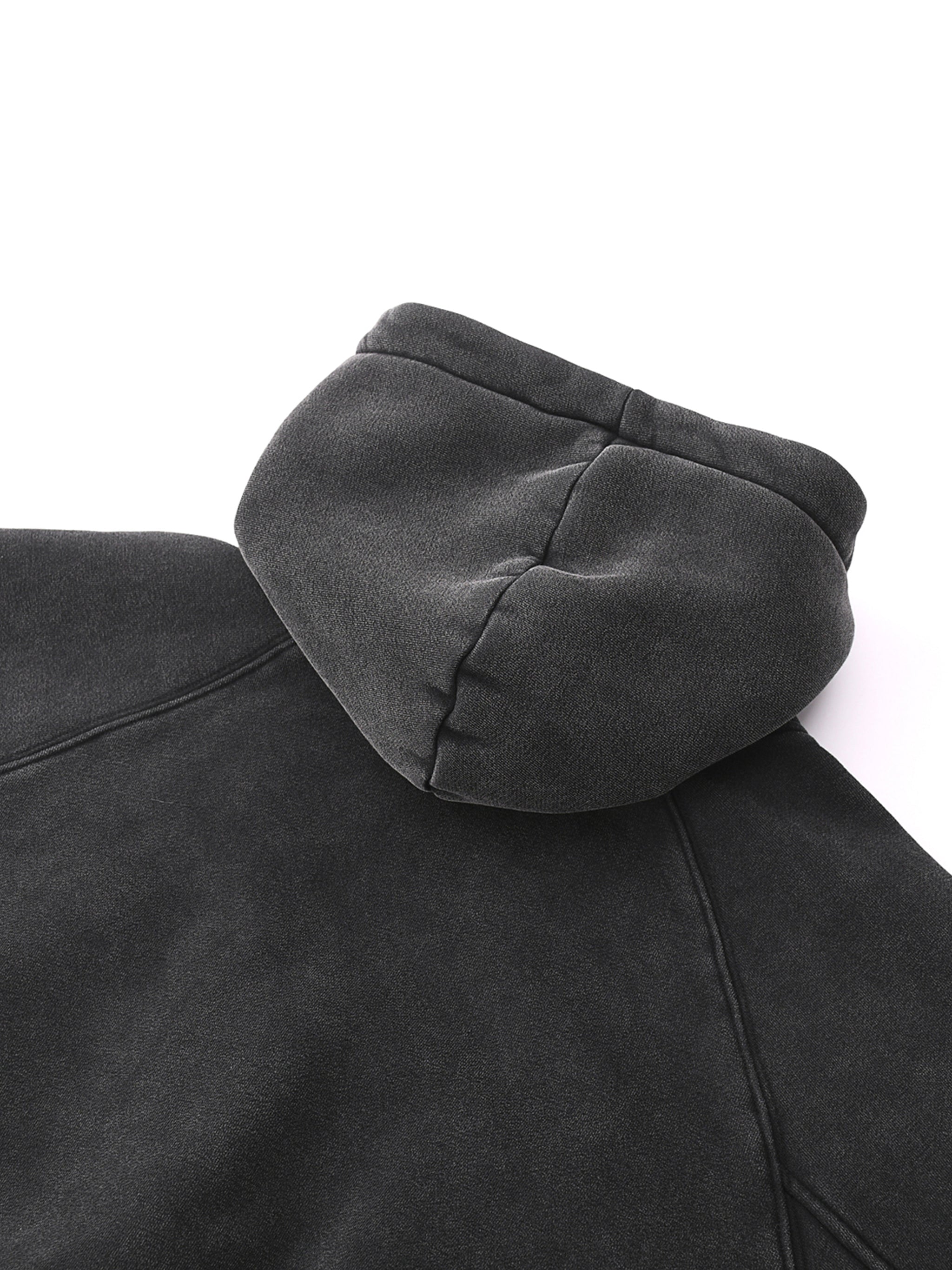 Close-up of black snow-washed cropped hoodie fabric and hood, heavyweight streetwear