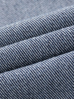 Close-up of heavyweight denim jeans fabric with textured sun-fade pattern