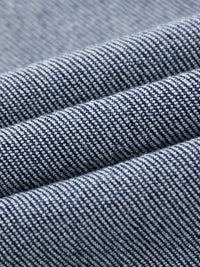 Close-up of heavyweight denim jeans fabric with textured sun-fade pattern