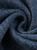 Close-up of heavyweight sun-fade denim fabric texture with visible weave pattern.
