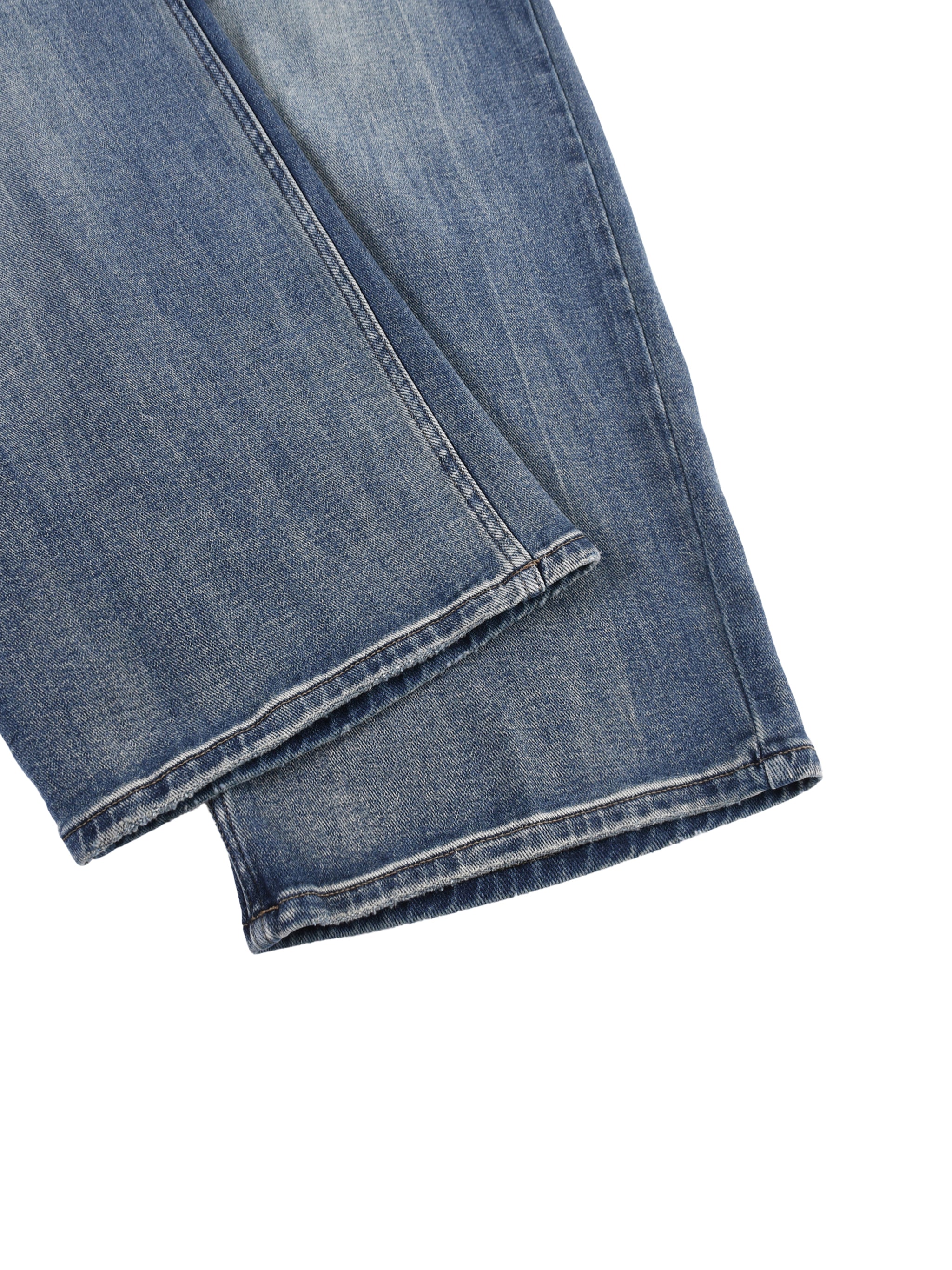 Close-up of heavyweight denim jeans with sun-fade effect and reinforced hem detail