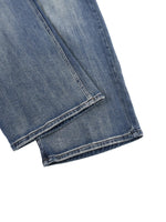 Close-up of heavyweight denim jeans with sun-fade effect and reinforced hem detail
