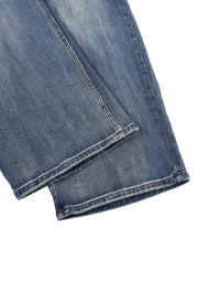 Close-up of heavyweight denim jeans with sun-fade effect and reinforced hem detail