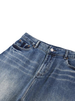 Heavyweight denim jeans with sun-faded wash and classic five-pocket design on white background