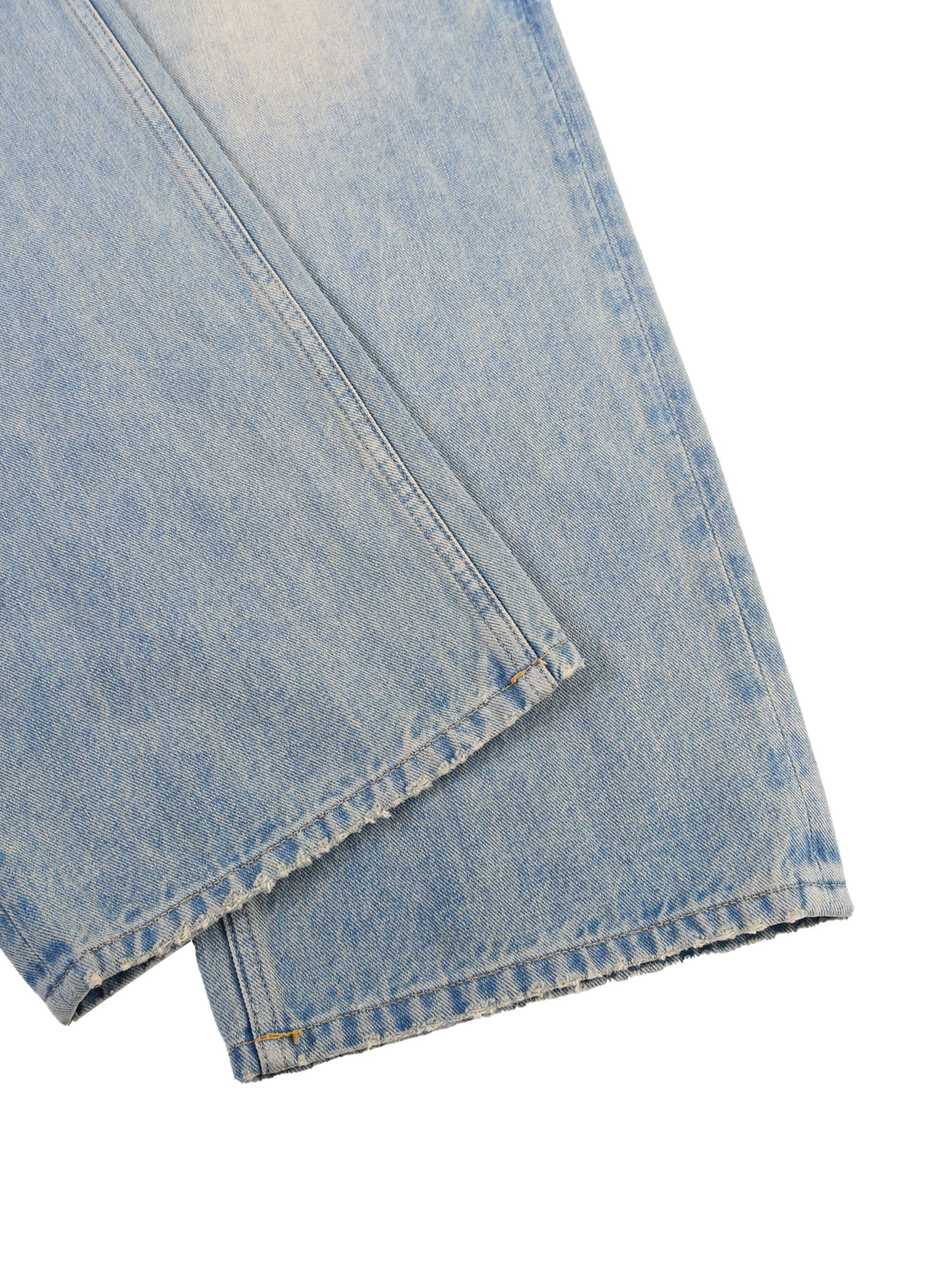 Light wash denim jeans with raw hem and subtle sun-faded detailing on white background