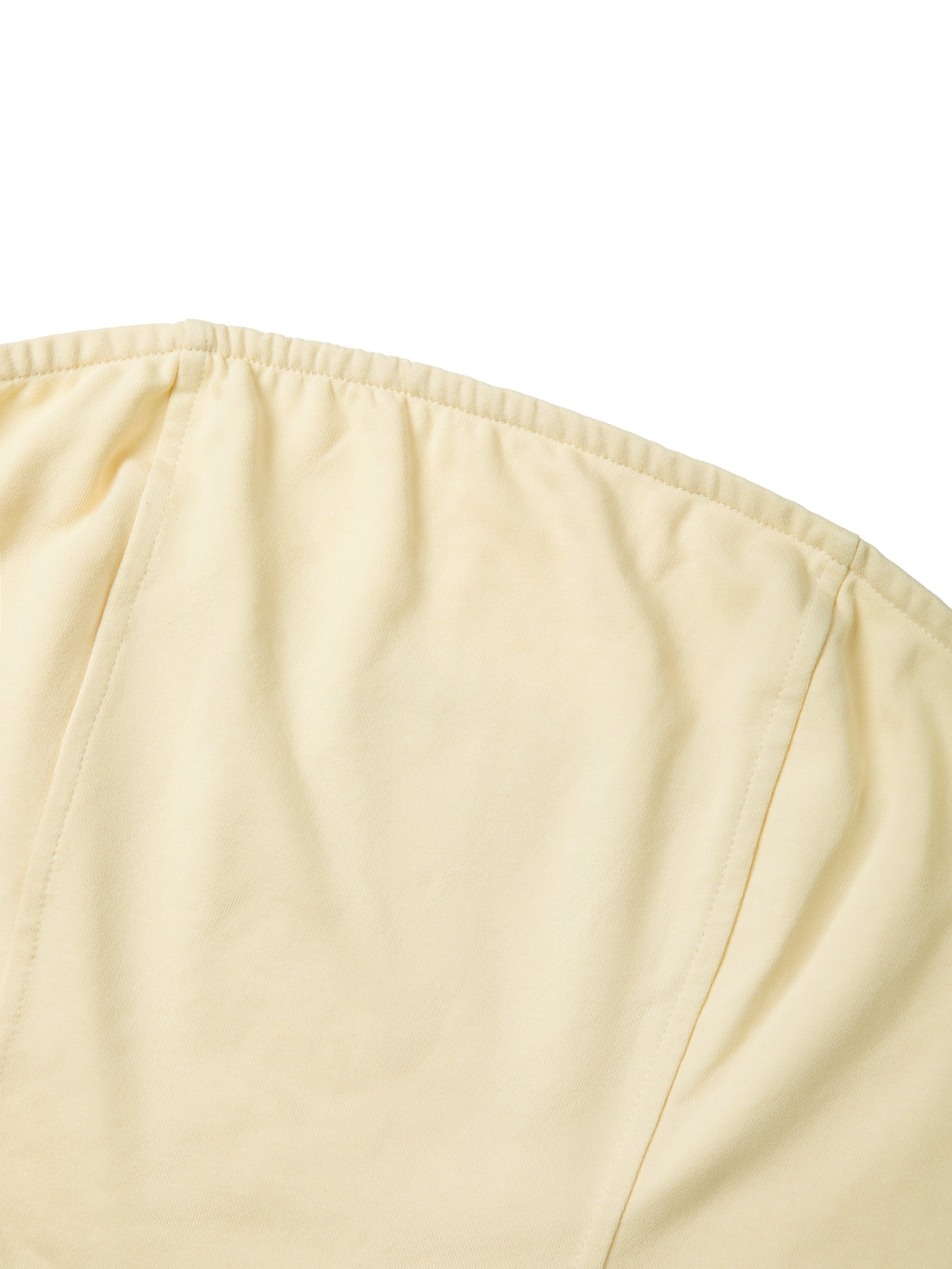 Close-up of beige women's cropped tube top with soft fabric and seam details
