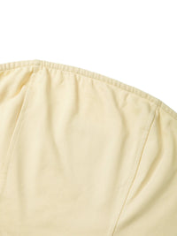 Close-up of beige women's cropped tube top with soft fabric and seam details