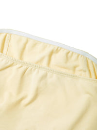 Close-up of yellow women's cropped tube top with elastic band and soft fabric texture